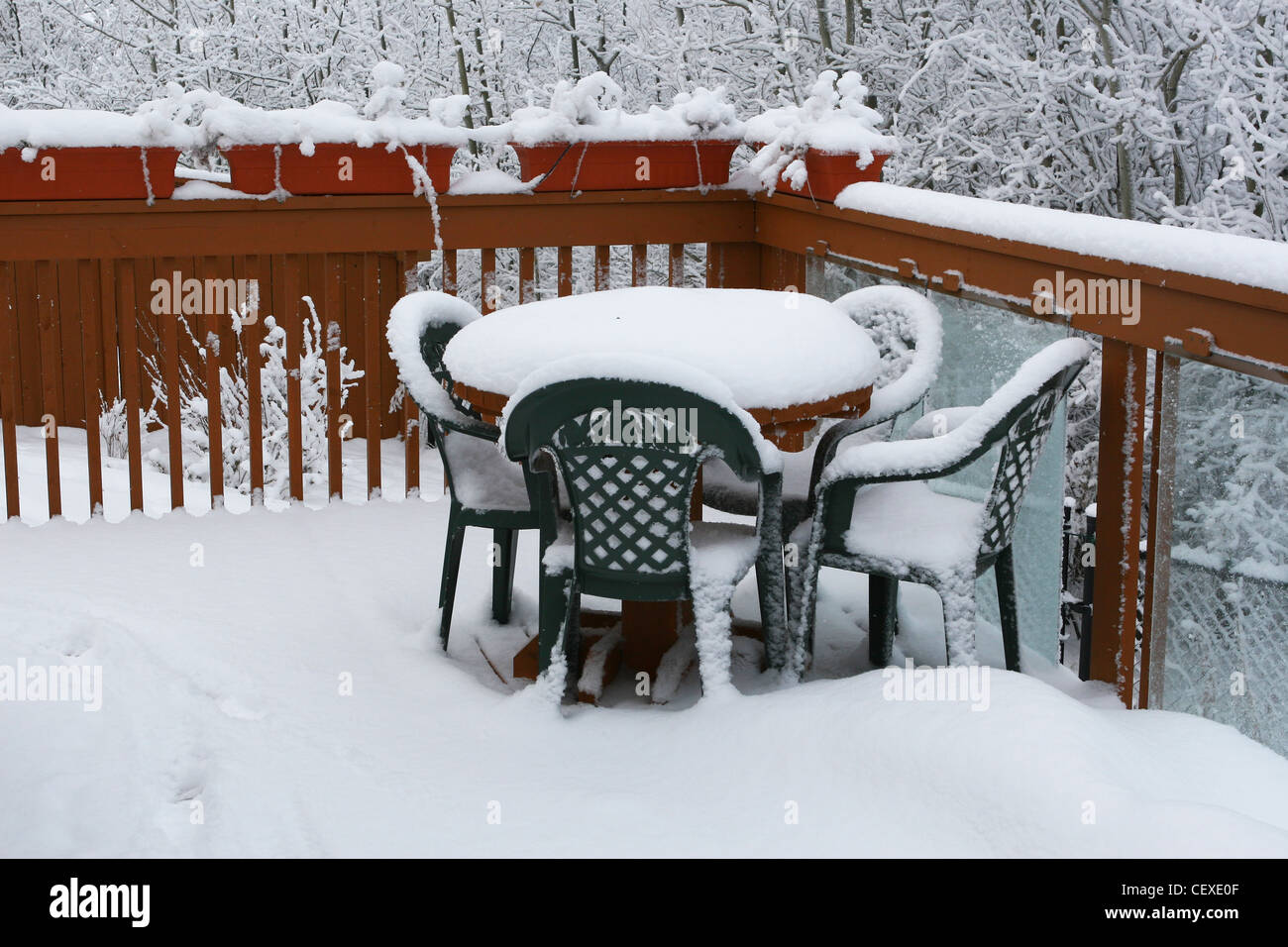 Winter scenes from Calgary,  Alberta, Canada.   Picnic table and chairs on back deck. Stock Photo