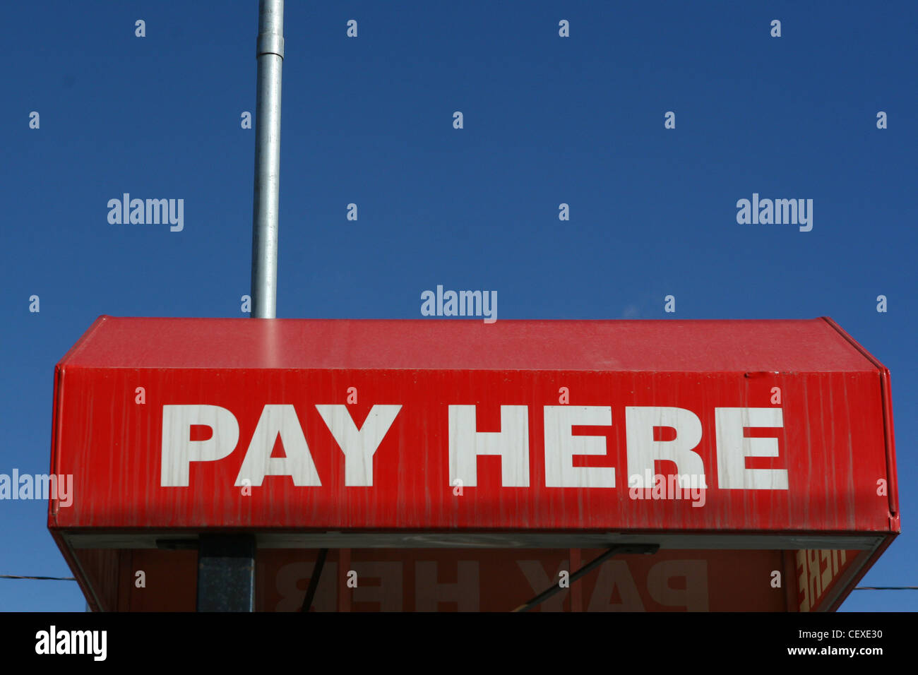 Red and white pay here sign. Stock Photo