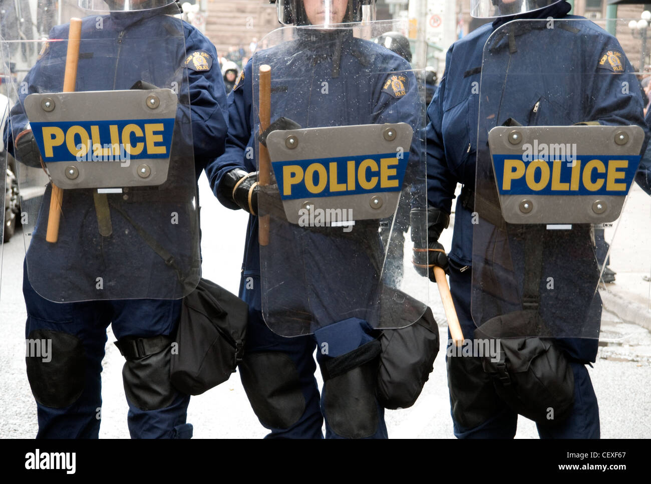 RCMP Riot police facing protesters with shields and batons on a downtown street during the G20 economic summit in 2010, Toronto, Ontario, Canada. Stock Photo