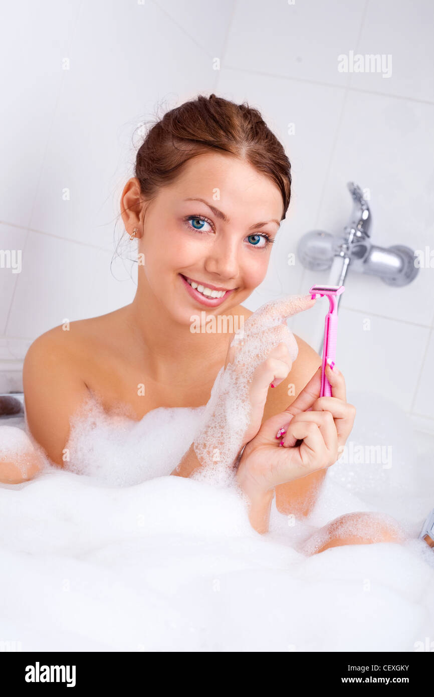 Young woman shaving legs bath spa water hires stock photography and