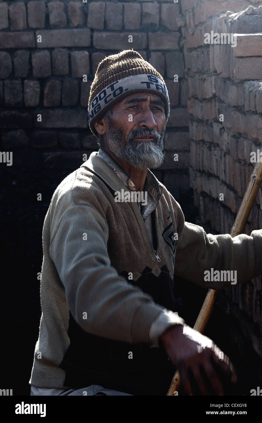 Man working in the brick kiln. Stock Photo