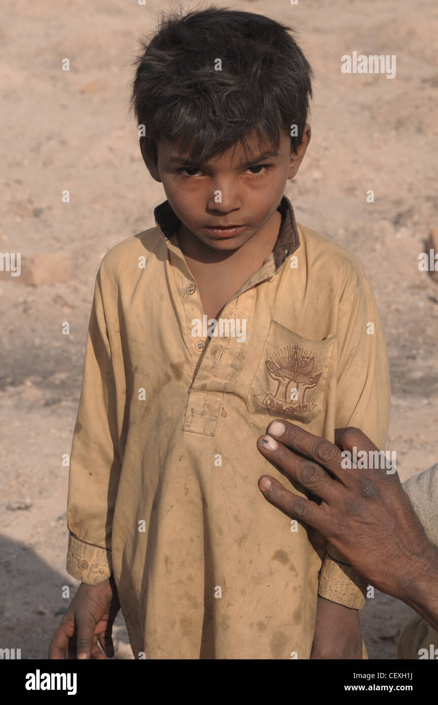 A dirty boy near a brick kiln near Islamabad Stock Photo
