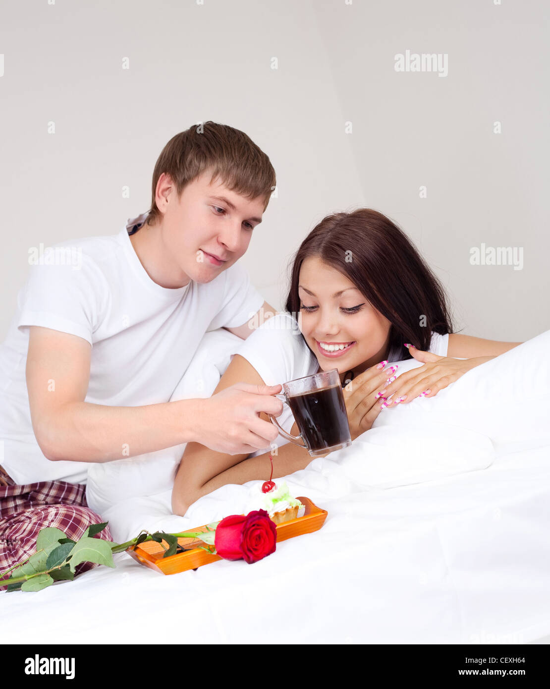 happy young couple having breakfast in bed Stock Photo Alamy