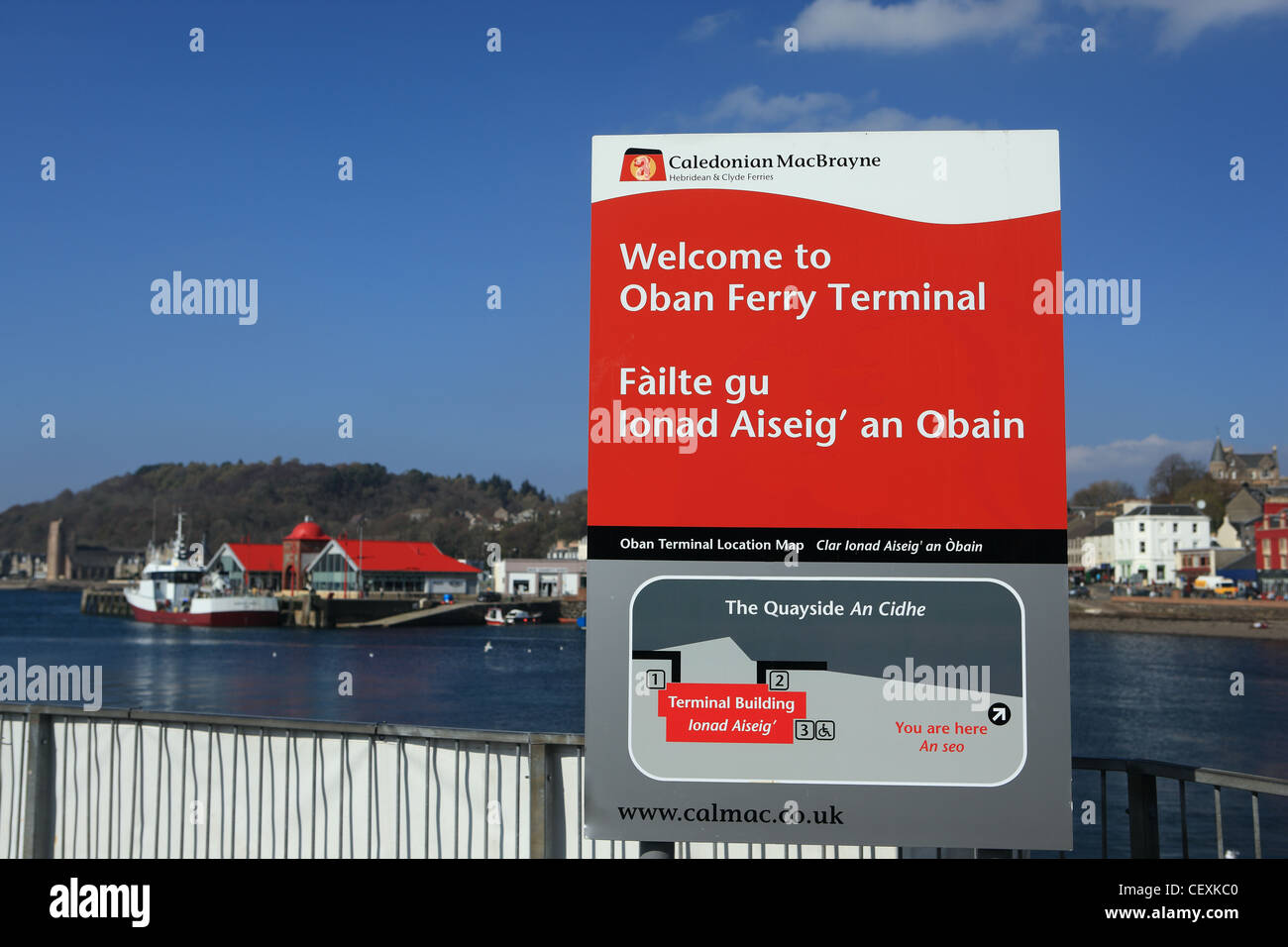 Oban ferry terminal sign and the town of Oban in the background across Oban Bay Stock Photo
