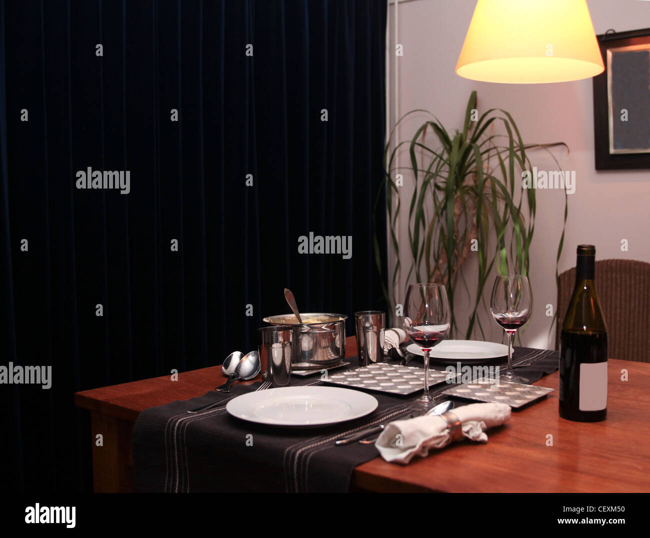 Tablesetting at home for two with glasses, wine and napkins Stock Photo