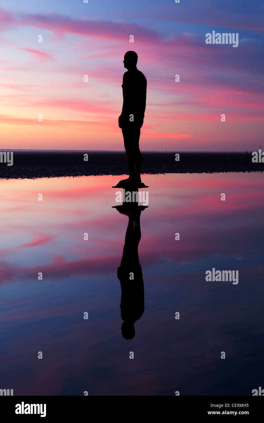 Antony Gormley Statue's Silhouetted, Twilight, Another Place, Crosby. Stock Photo