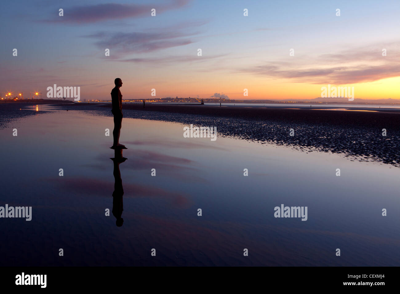 Antony Gormley Statue's Silhouetted, Twilight, Another Place, Crosby. Stock Photo