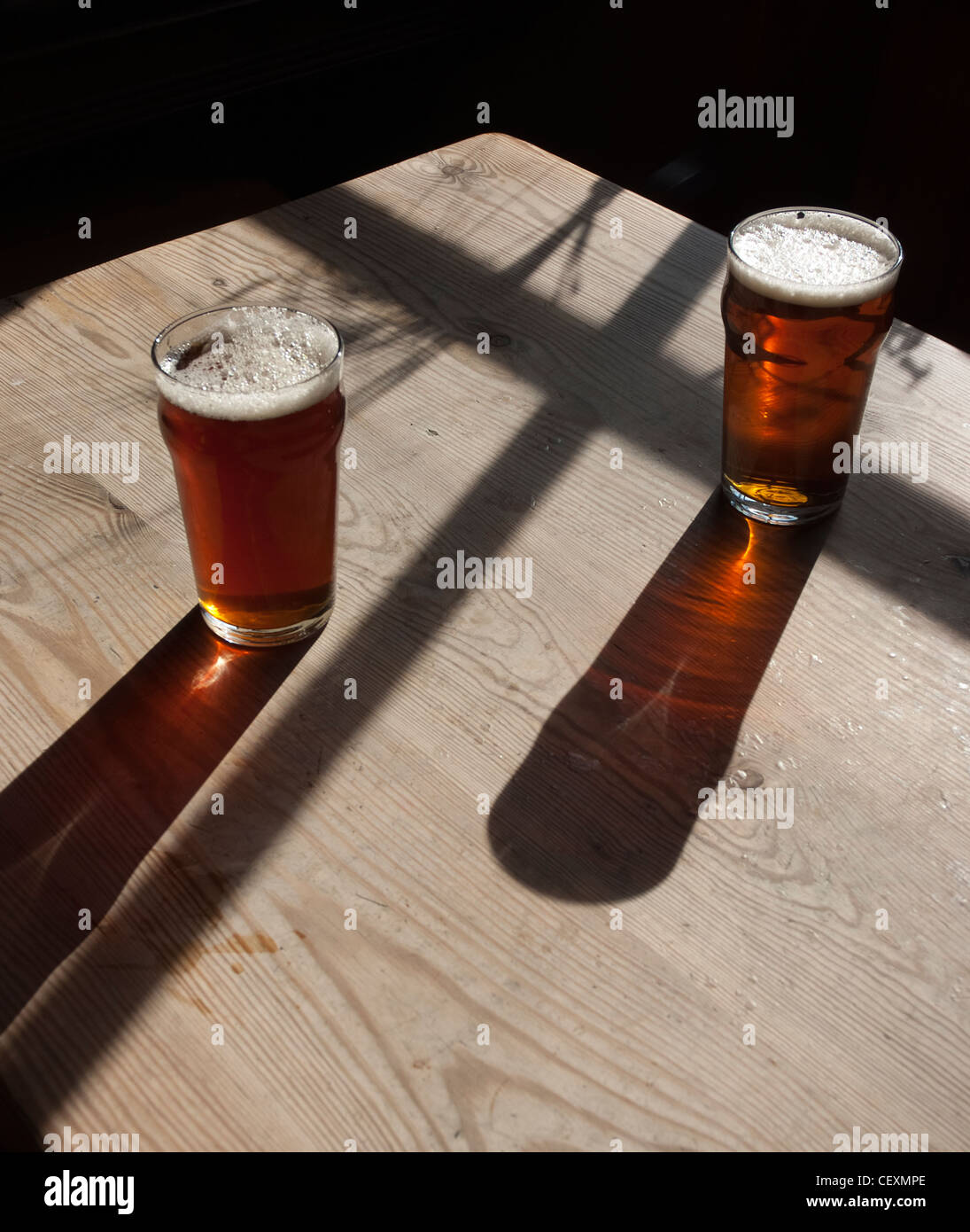 pints of beer on pub table Stock Photo