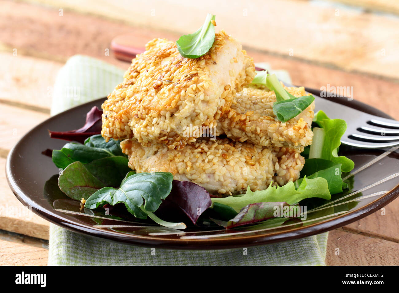 fried chicken in sesame seeds with salad Stock Photo Alamy