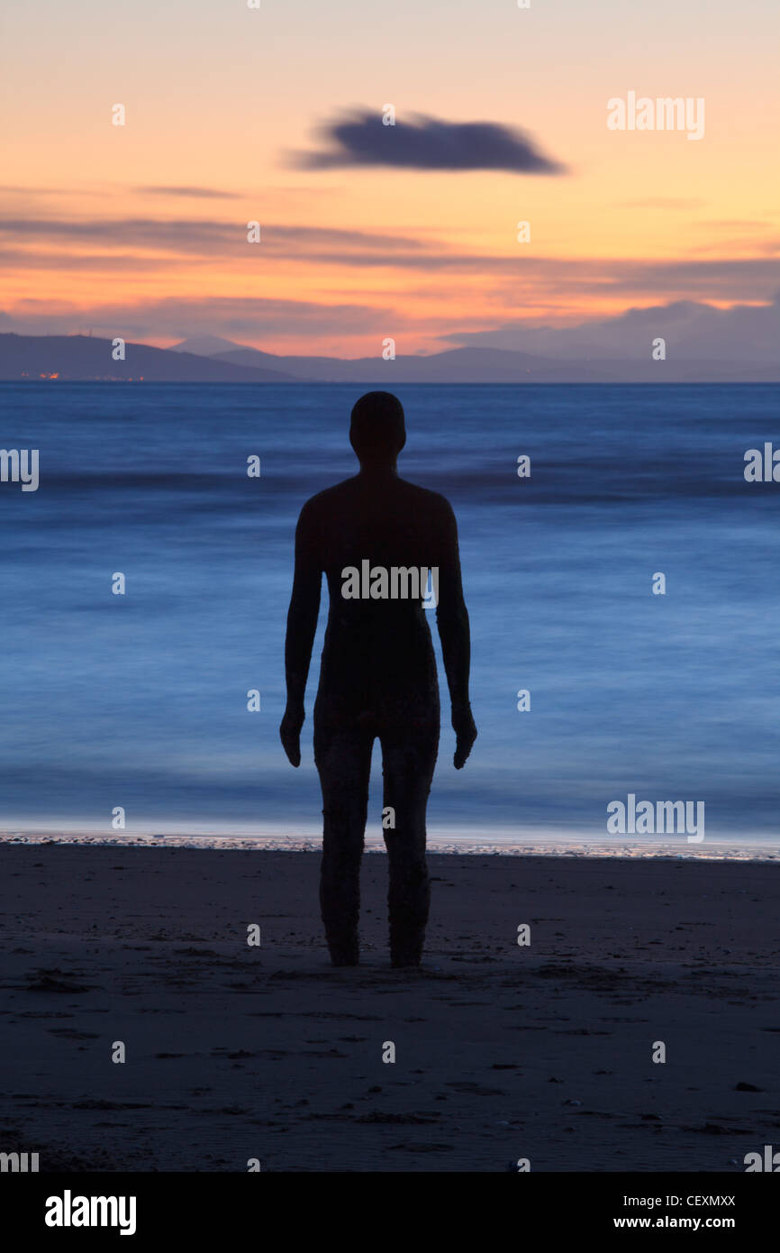 Antony Gormley Statue Silhouetted, Twilight, Another Place, Crosby. Stock Photo