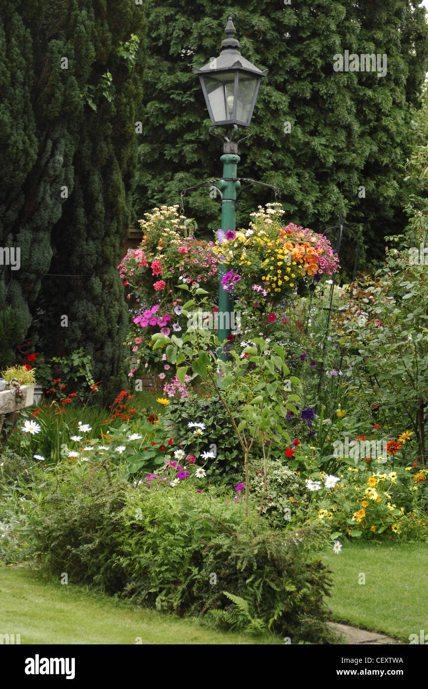 All Seasons Garden Garden light with hanging baskets planted with a