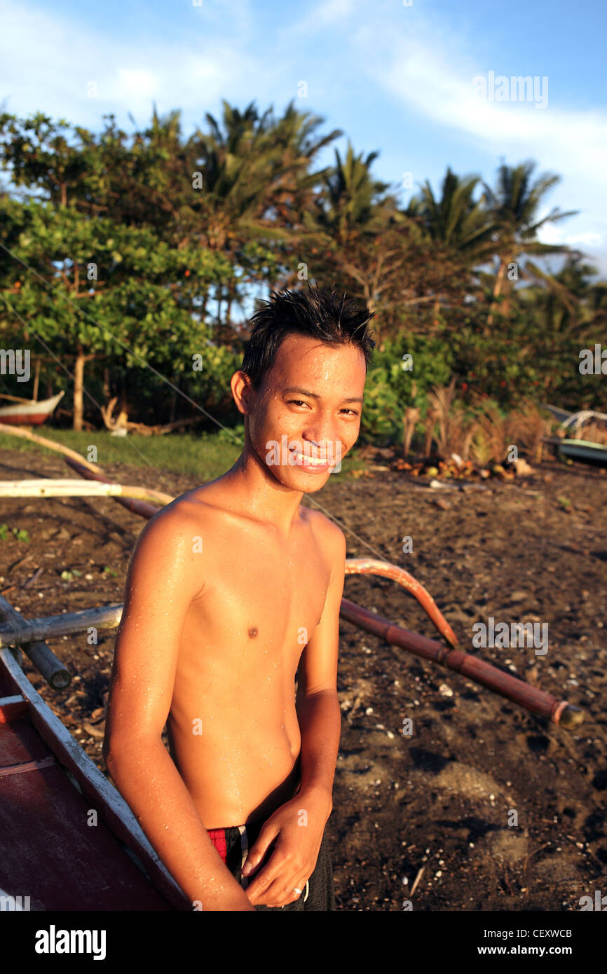Portrait of happy teenage boy on beach. Donsol, Sorsogon, Luzon, Albay, Bicol, Philippines, South-East Asia, Asia Stock Photo