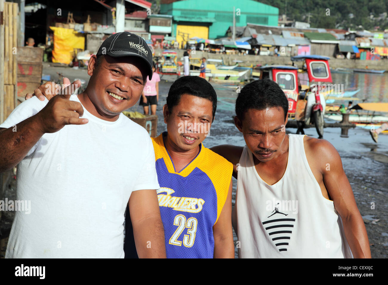 Group of happy men on waterfront. Catbalogan, Samar Island, Western Samar, Eastern Visayas, Philippines, South-East Asia, Asia Stock Photo