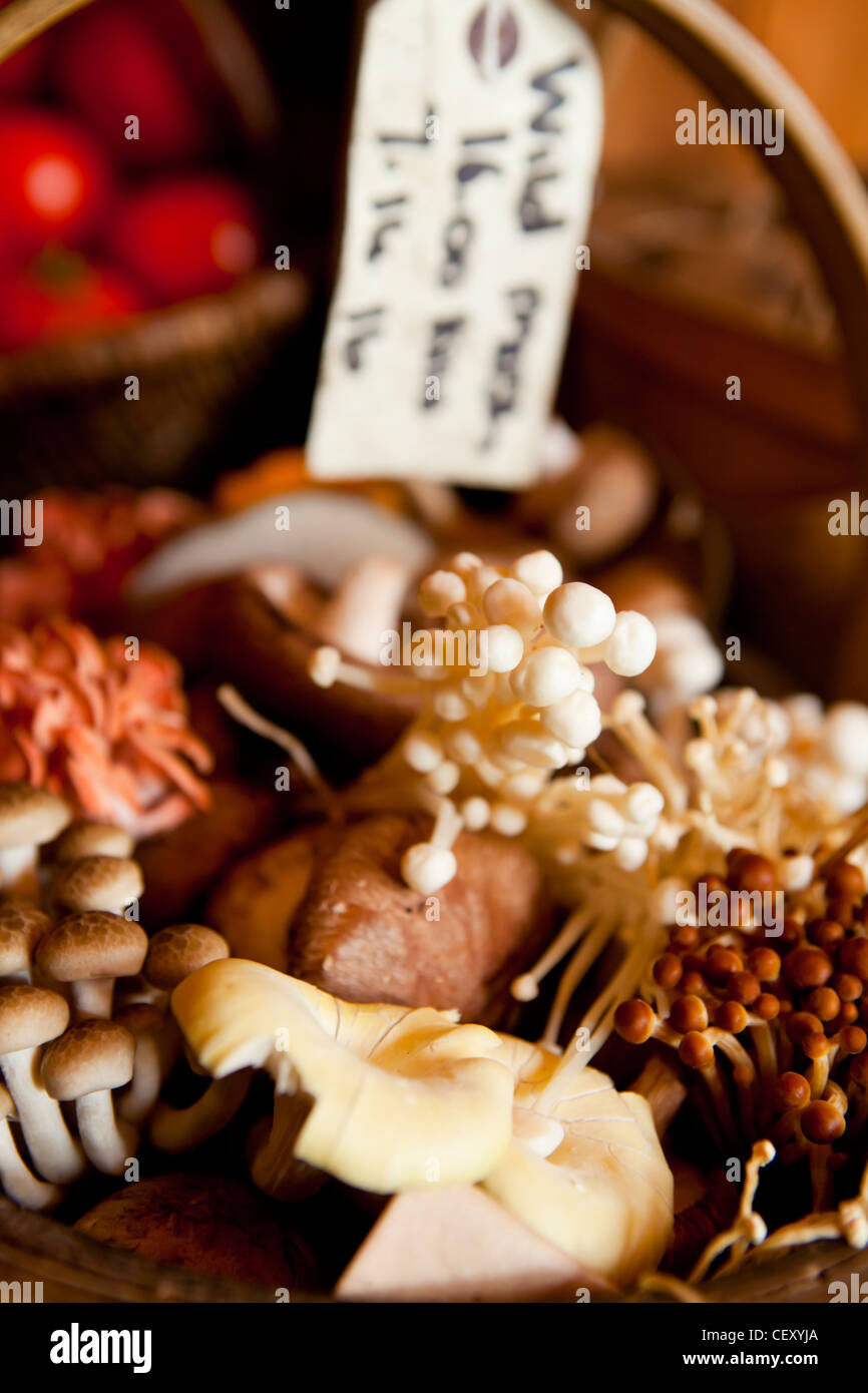 A traditional basket of wild mushrooms in a fruit and veg shop in Greenwich Stock Photo