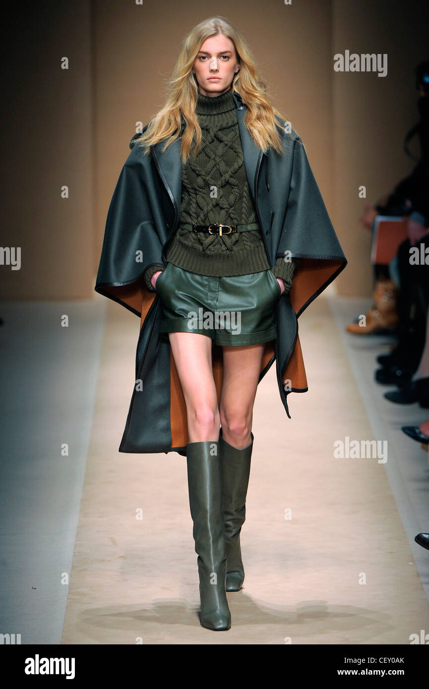 Salvatore Ferragamo Milan Ready to Wear Autumn Winter Green tones cloak  coat, belted cable knit jumper, leather shorts and Stock Photo - Alamy