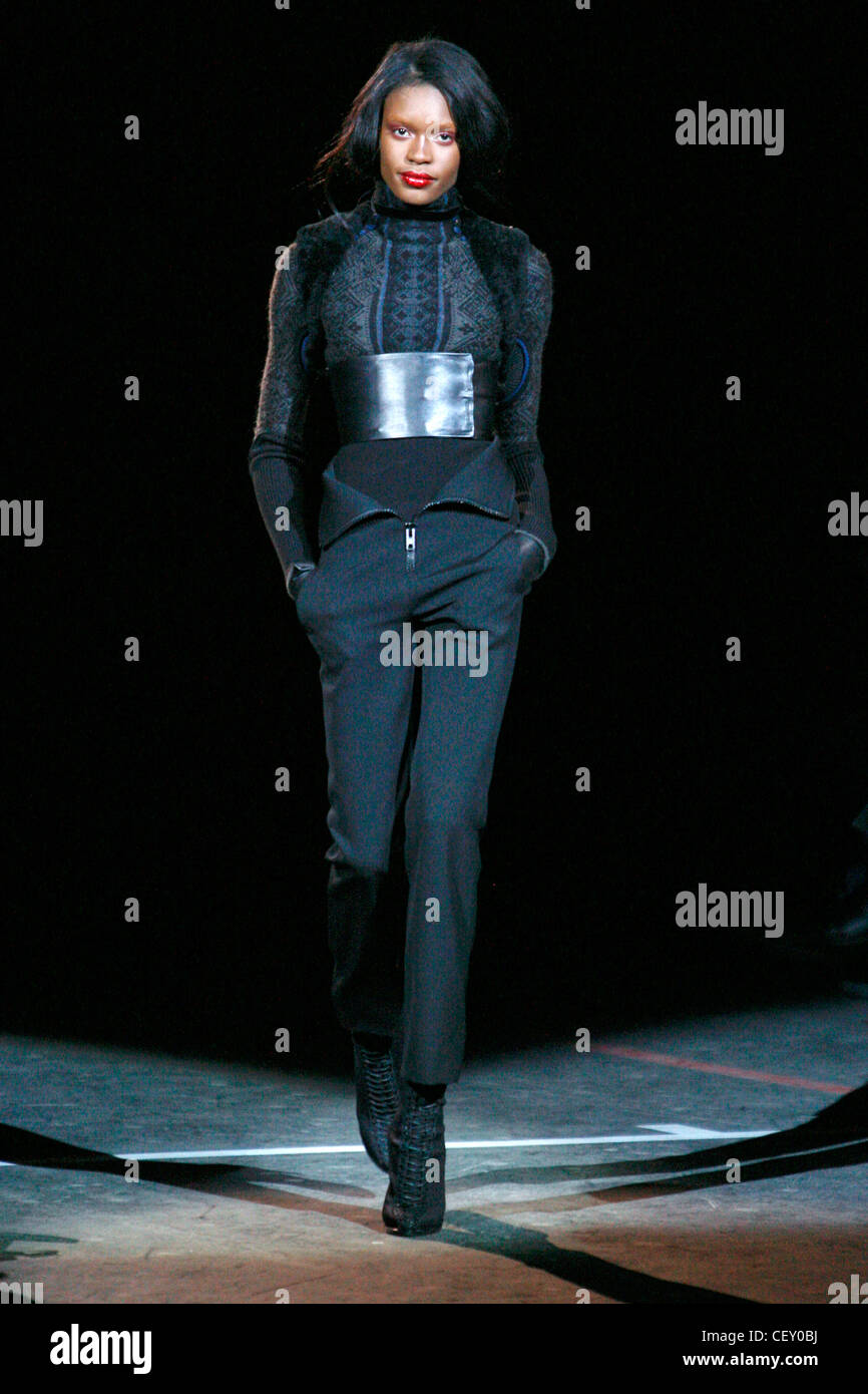 Givenchy Paris Ready to Wear Autumn Winter Patterned jumper, wide black belt, high waisted trousers zip detail, black laced up Stock Photo