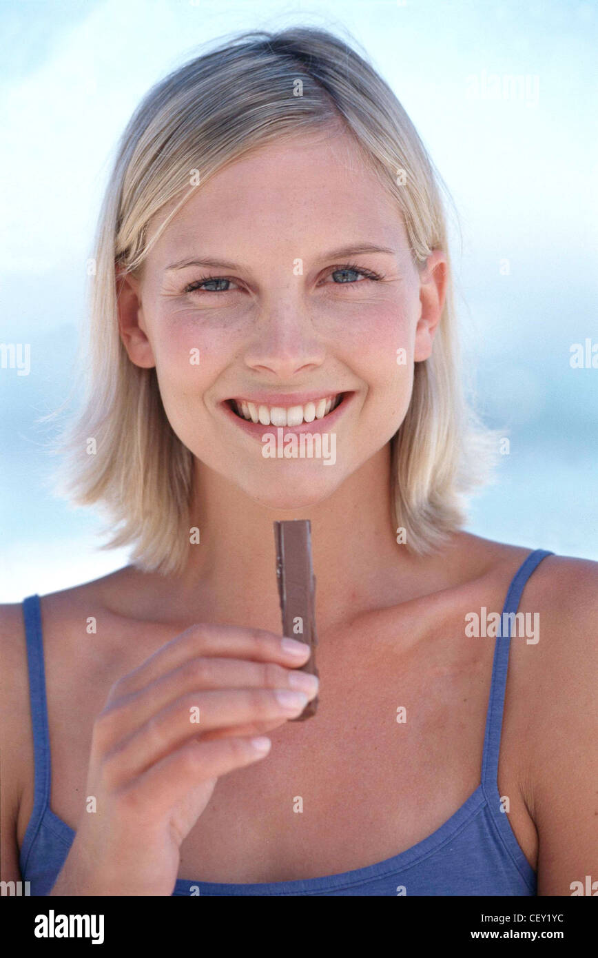 Tanned Female Chin Length Blonde Hair Wearing Blue Vest Top