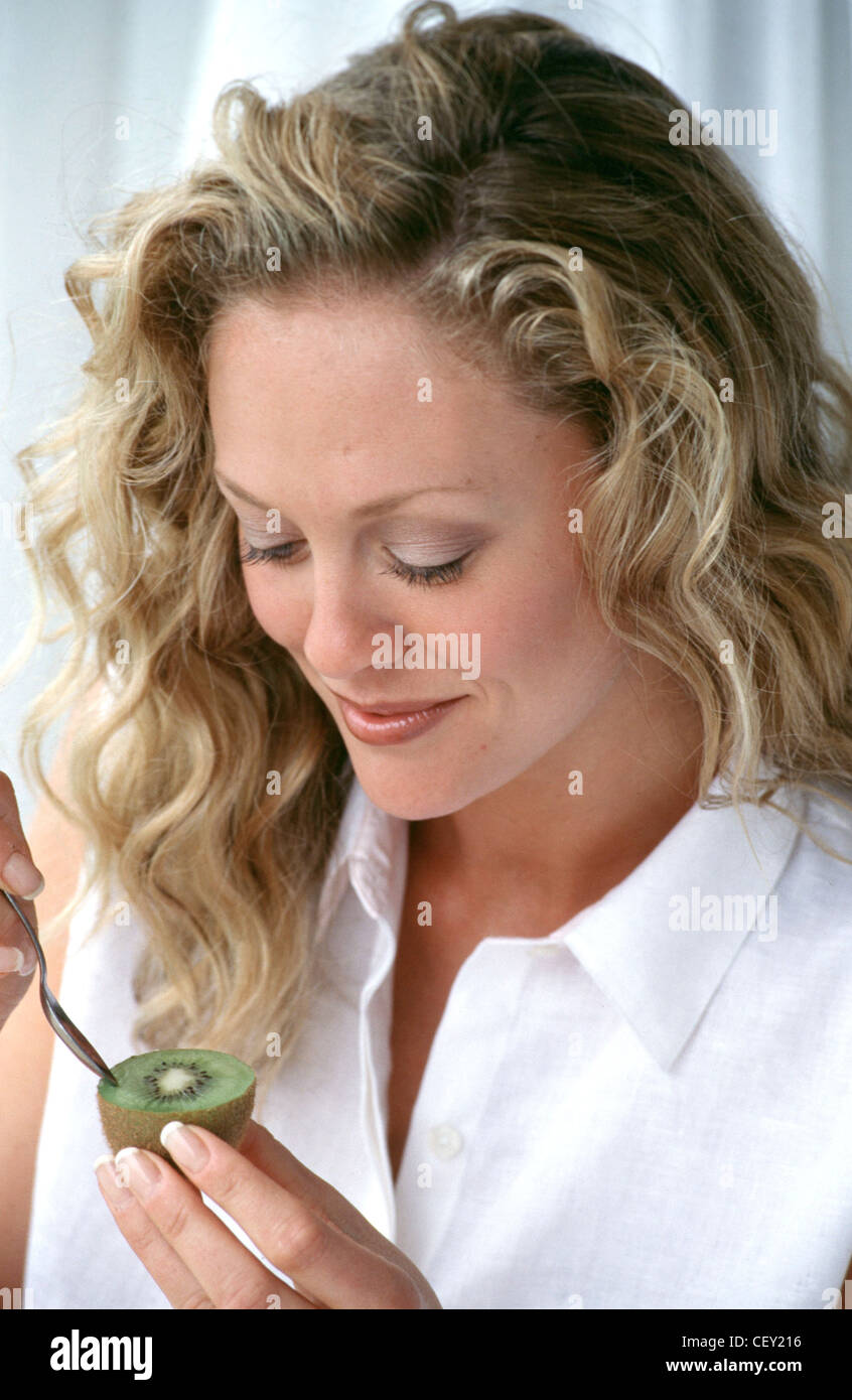 Female With Long Wavy Blonde Hair Wearing Subtle Make Up And White
