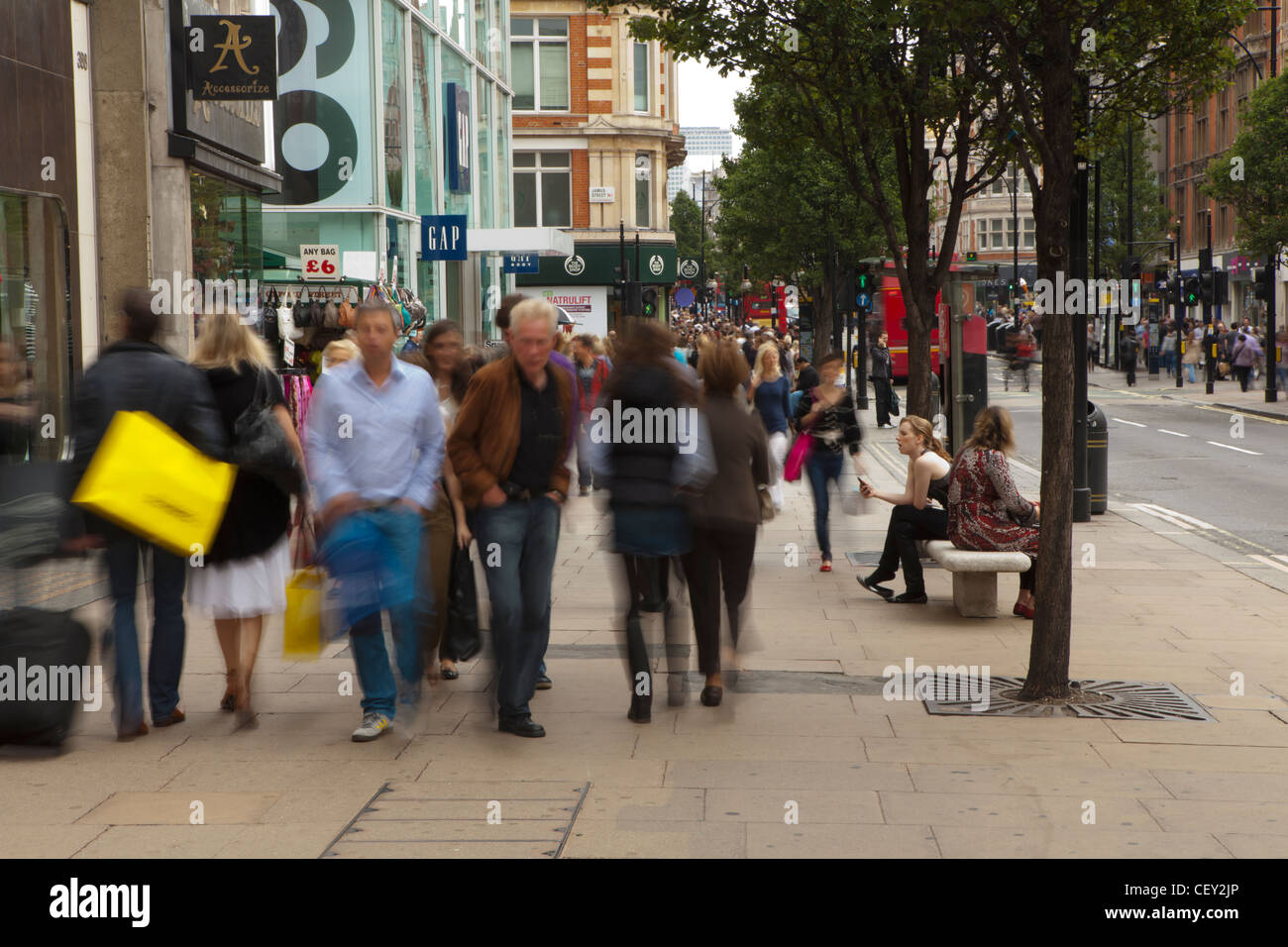 A view down Oxford street, with shoppers moving along the path Stock Photo