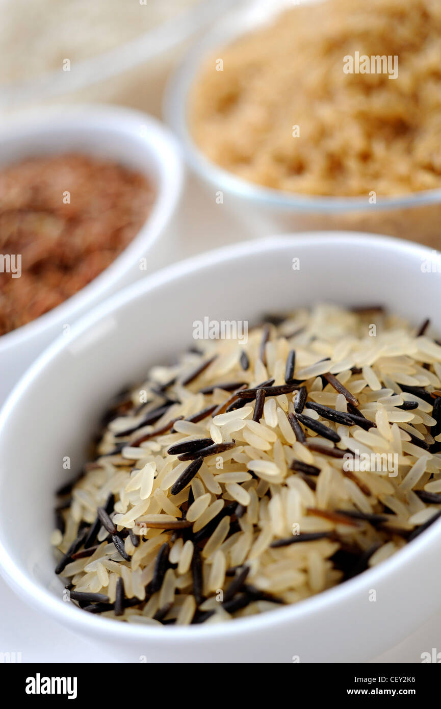 Four bowls of different varieties of rice, with a bowl of long grain
