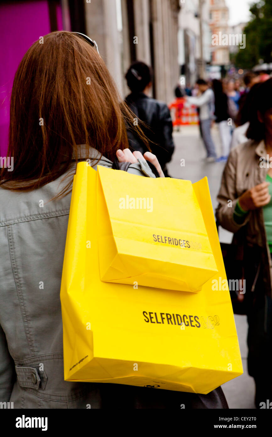 A shopper carries a Louis Vuitton shopping bag on London's Oxford Street  after the shops were allowed to reopen. (Photo by Dave Rushen / SOPA  Images/Sipa USA Stock Photo - Alamy