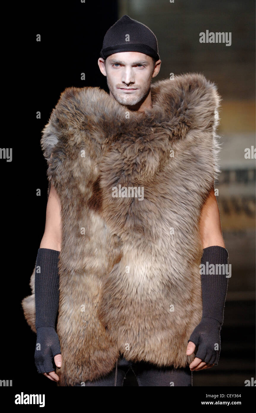 Vivienne Westwood Menswear Milan A W Male wearing a black stocking cap,  white make up on his face, a cave man like furry Stock Photo - Alamy