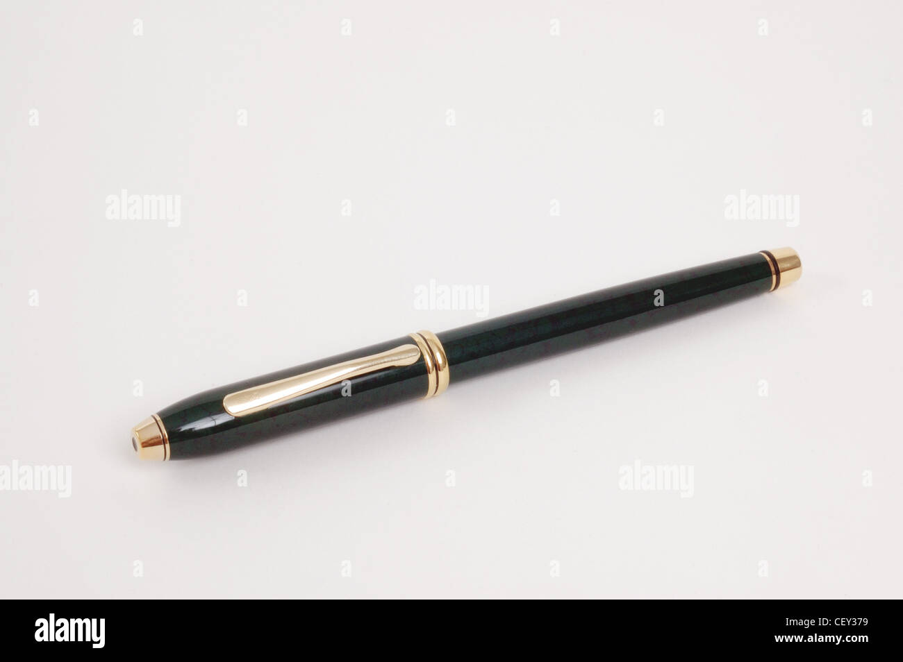 A black and gold fountain pen with the lid on, lying diagonally Stock Photo