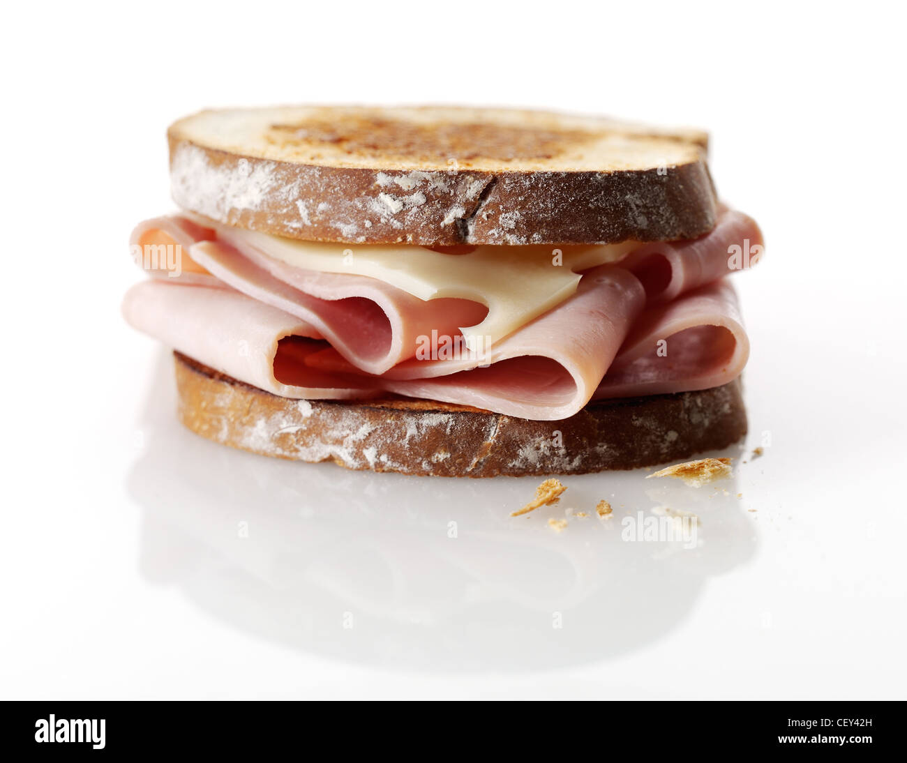 Ham and swiss cheese sandwich with toasted white bread on a reflective