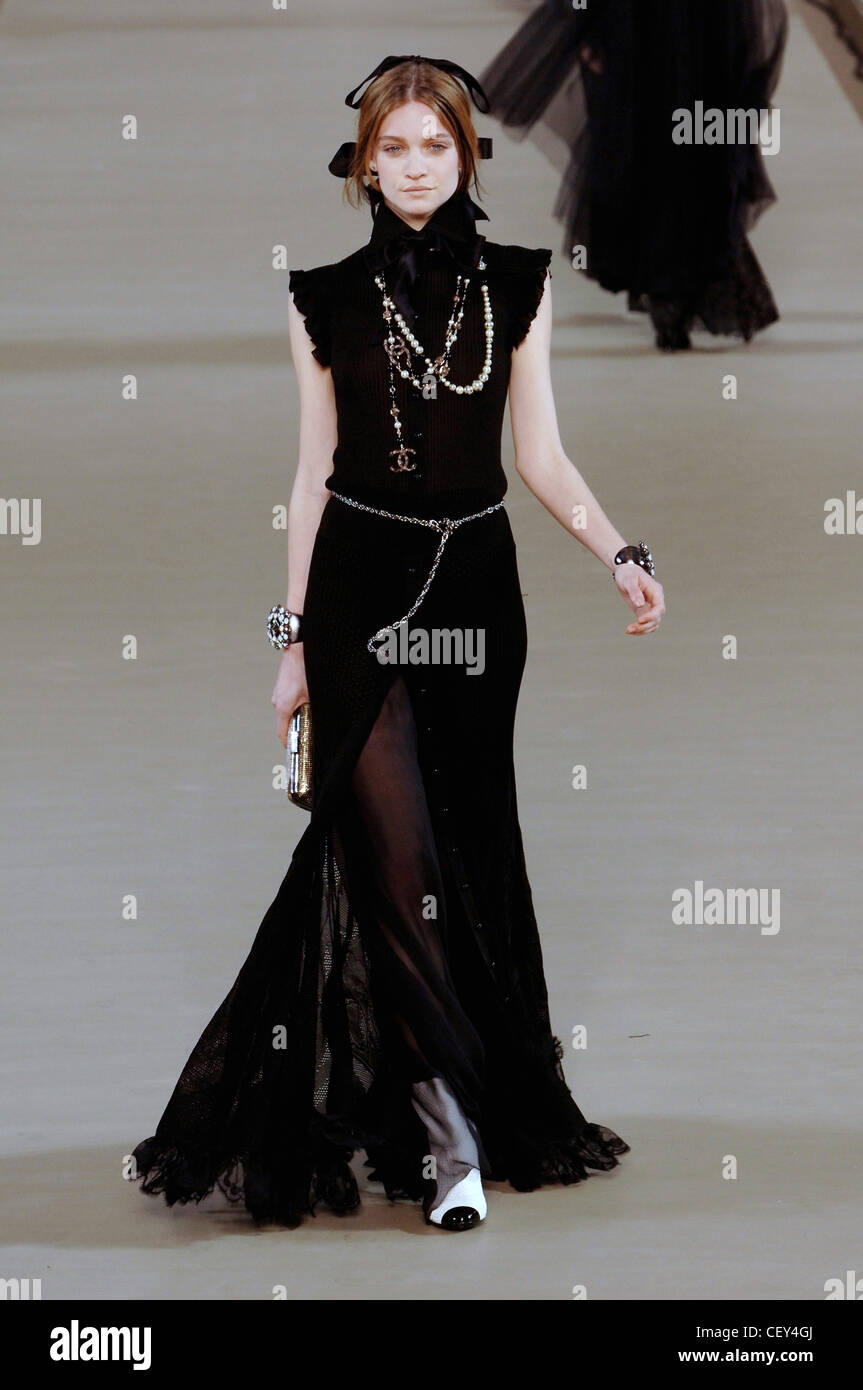 Chanel Ready to Wear Paris A W Model Lesly Masson straight brunette hair  wearing black bow at back of head and floorlength Stock Photo - Alamy