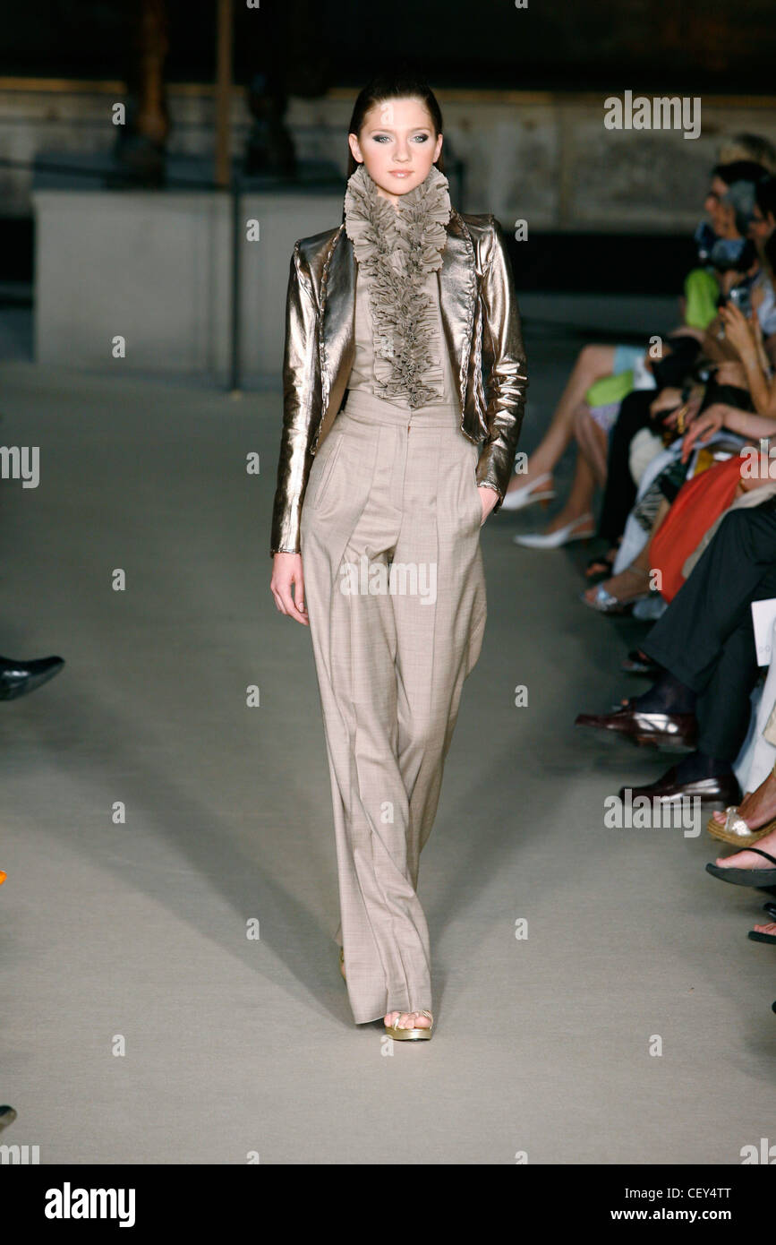 Dominique Sirop Paris Haute Couture Autumn Winter Brunette female model  wearing taupe coloured high waisted trousers and Stock Photo - Alamy