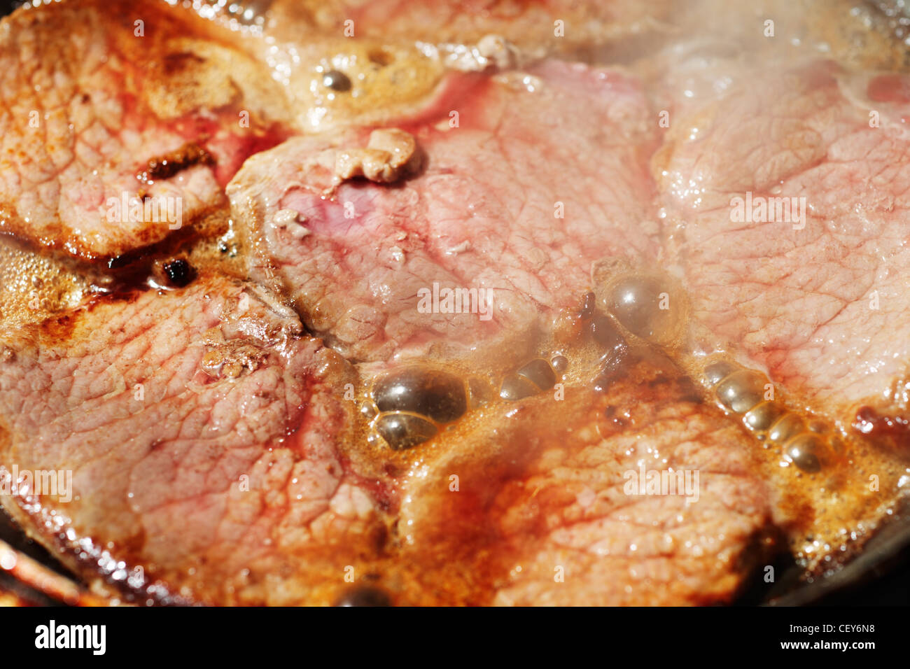 Fryed veal fillet in a frying pan Stock Photo