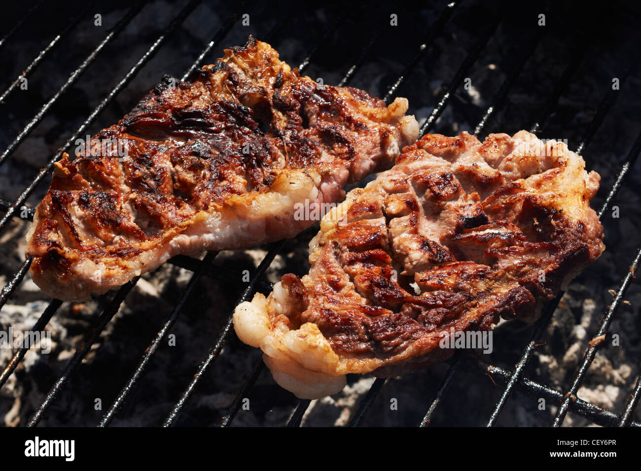 Pork-chop roasted on charcoal barbecue Stock Photo