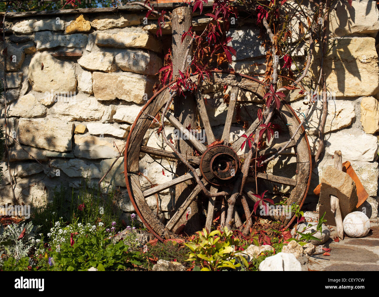 Traditional Bulgarian wooden wheel in country yard Stock Photo