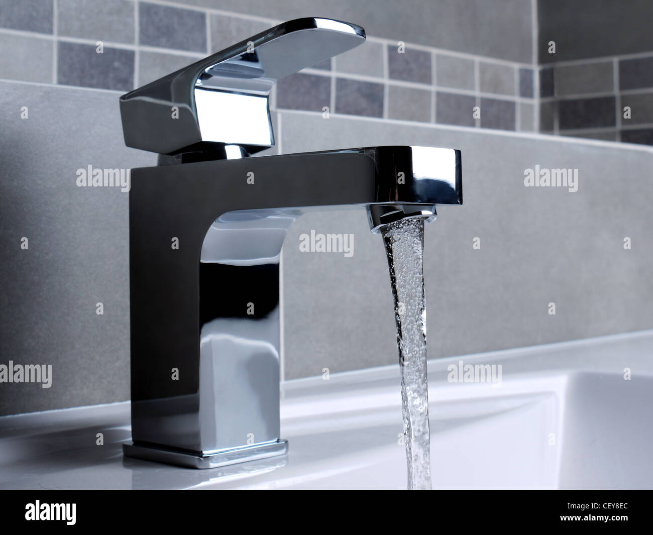 Modern bathroom chrome faucet with running water Stock Photo