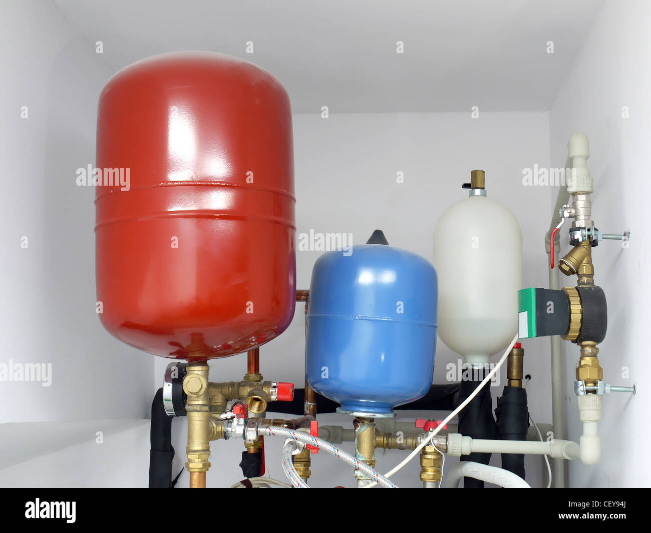 Group of expansion tanks in house boiler room Stock Photo