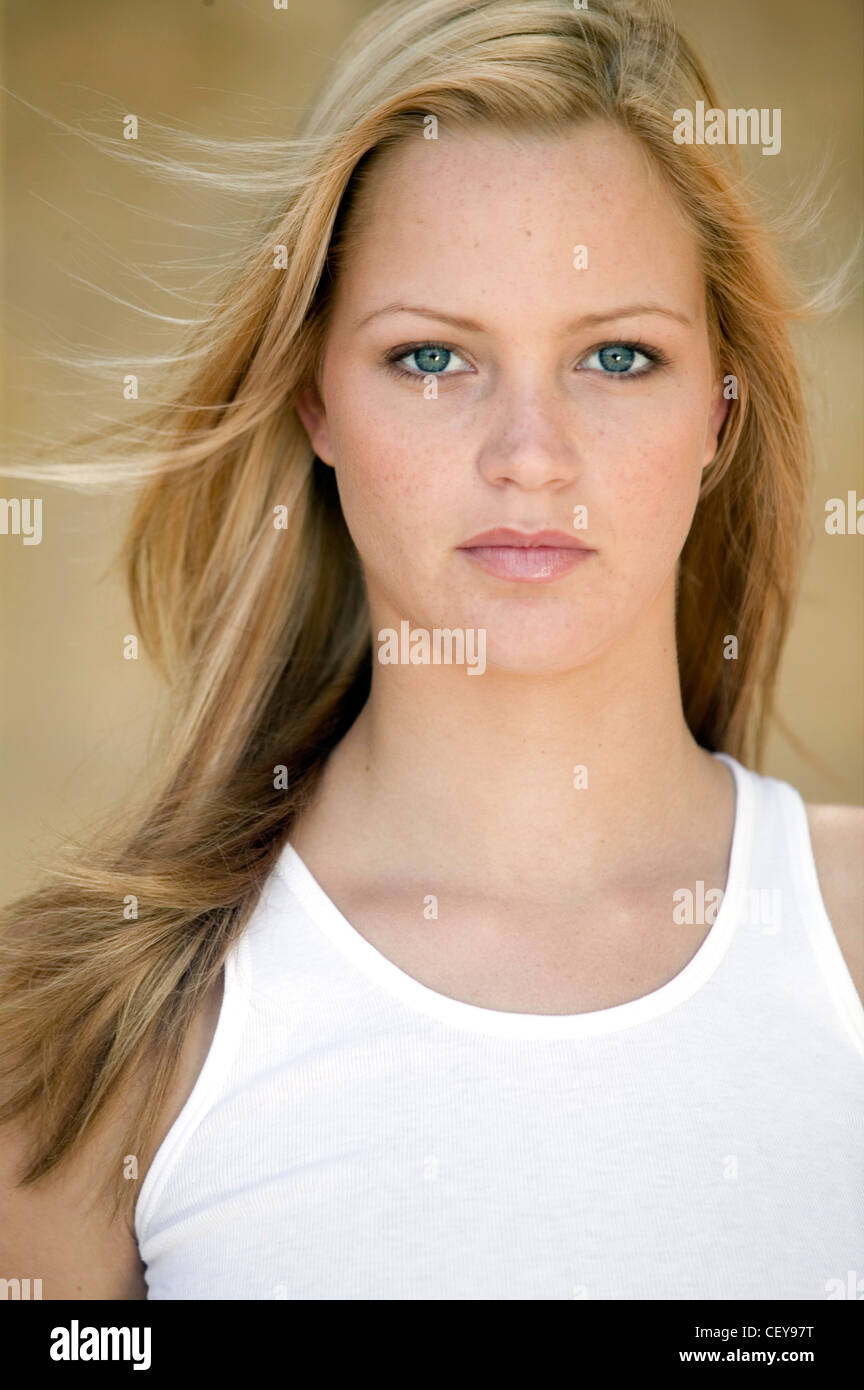 Female Long Straight Blonde Hair And Blue Eyes Wearing A White