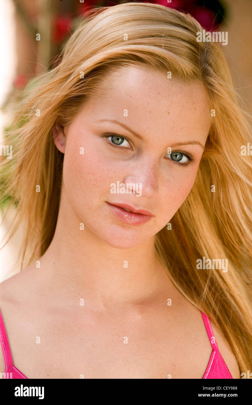 Female Straight Long Blonde Hair Worn Loose Wearing A Bright Pink