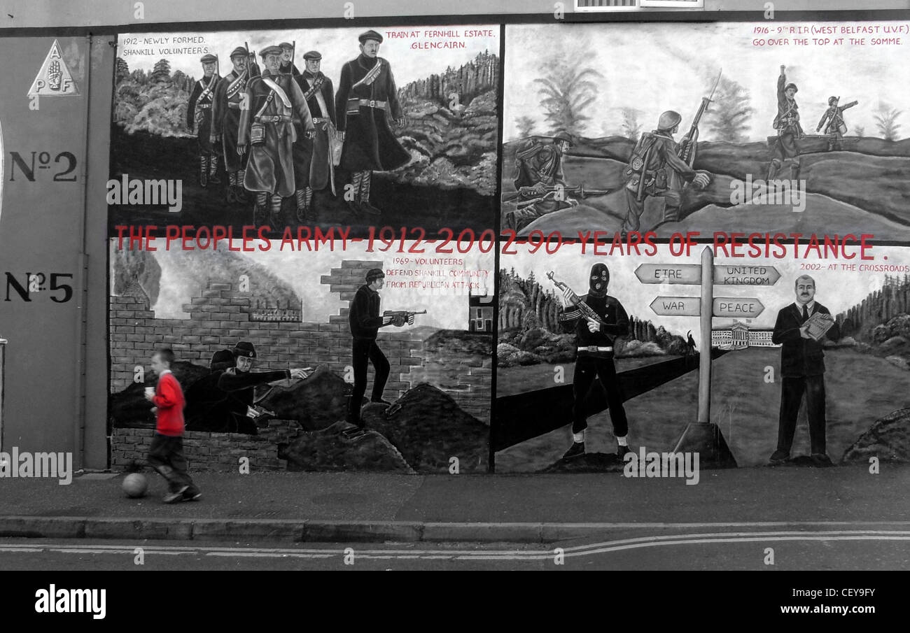 Boy kicking ball past the Shankill Road Mural, Belfast, Northern Ireland, UK, BT13 2AA near Ballysillan Stock Photo
