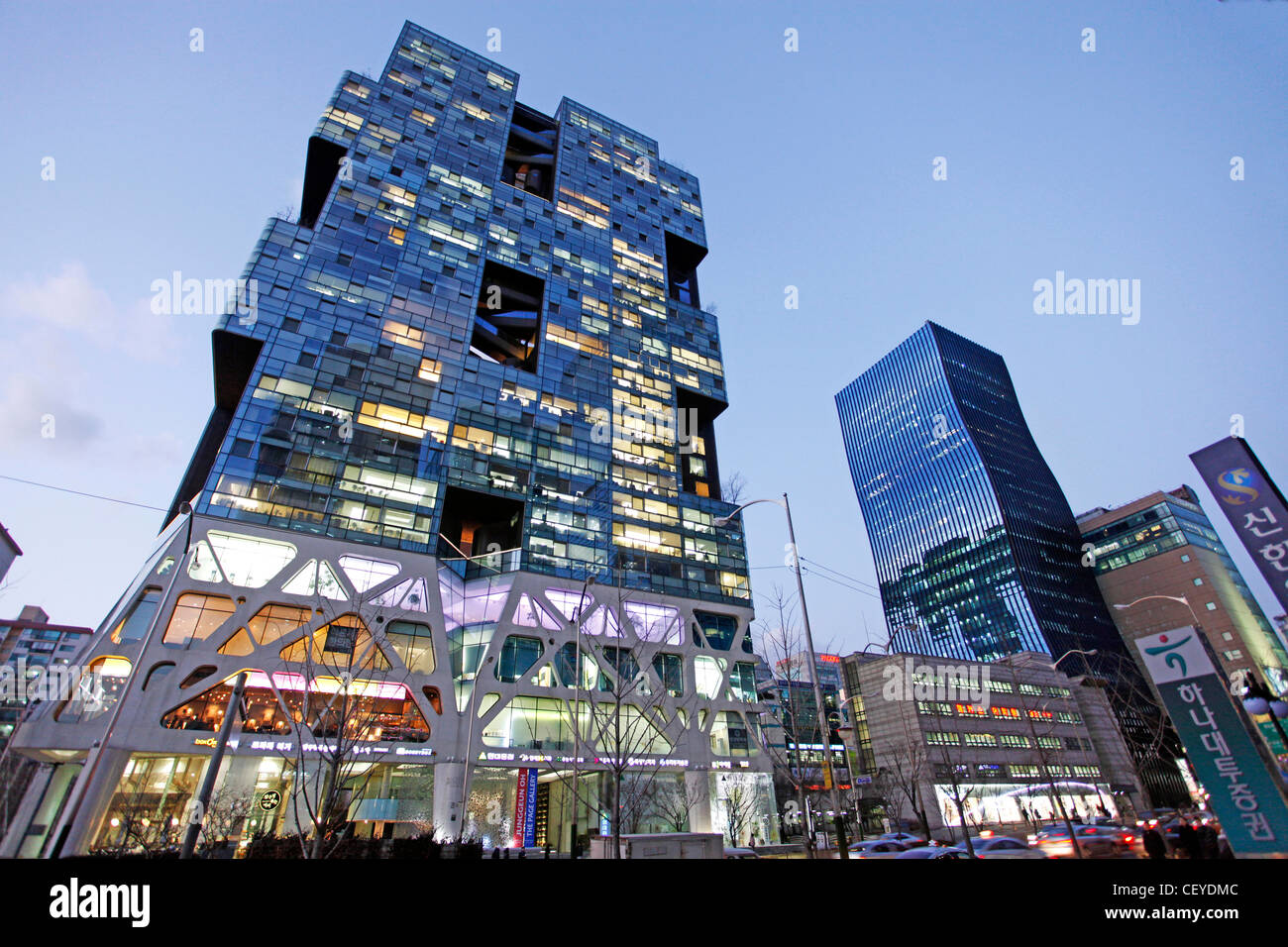 Modern architecture of office block buildings at sunset with lights in the Gangnam district of Seoul, South Korea Stock Photo
