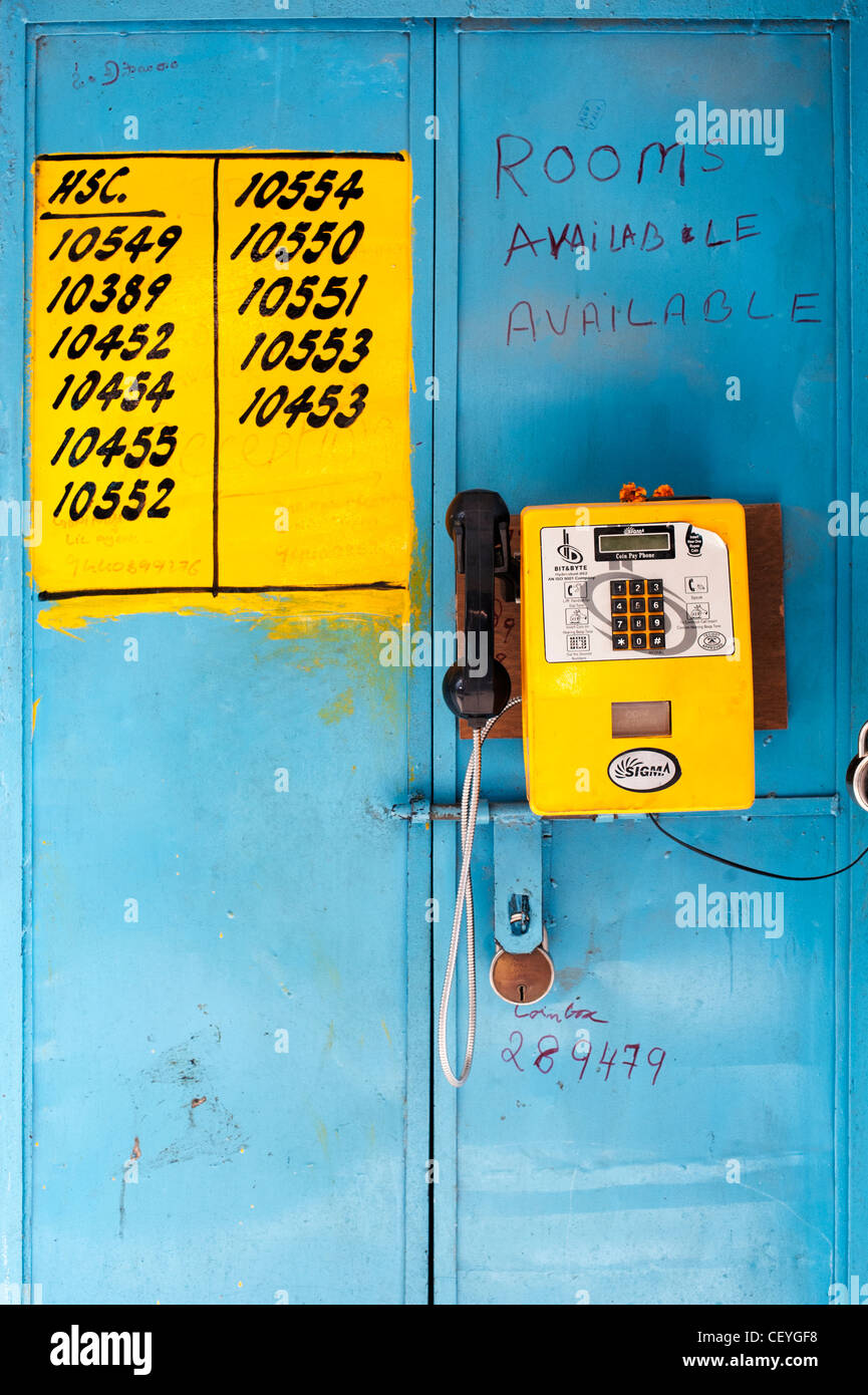 Indian public telephone attached to a door. Puttaparthi, Andhra Pradesh, India Stock Photo