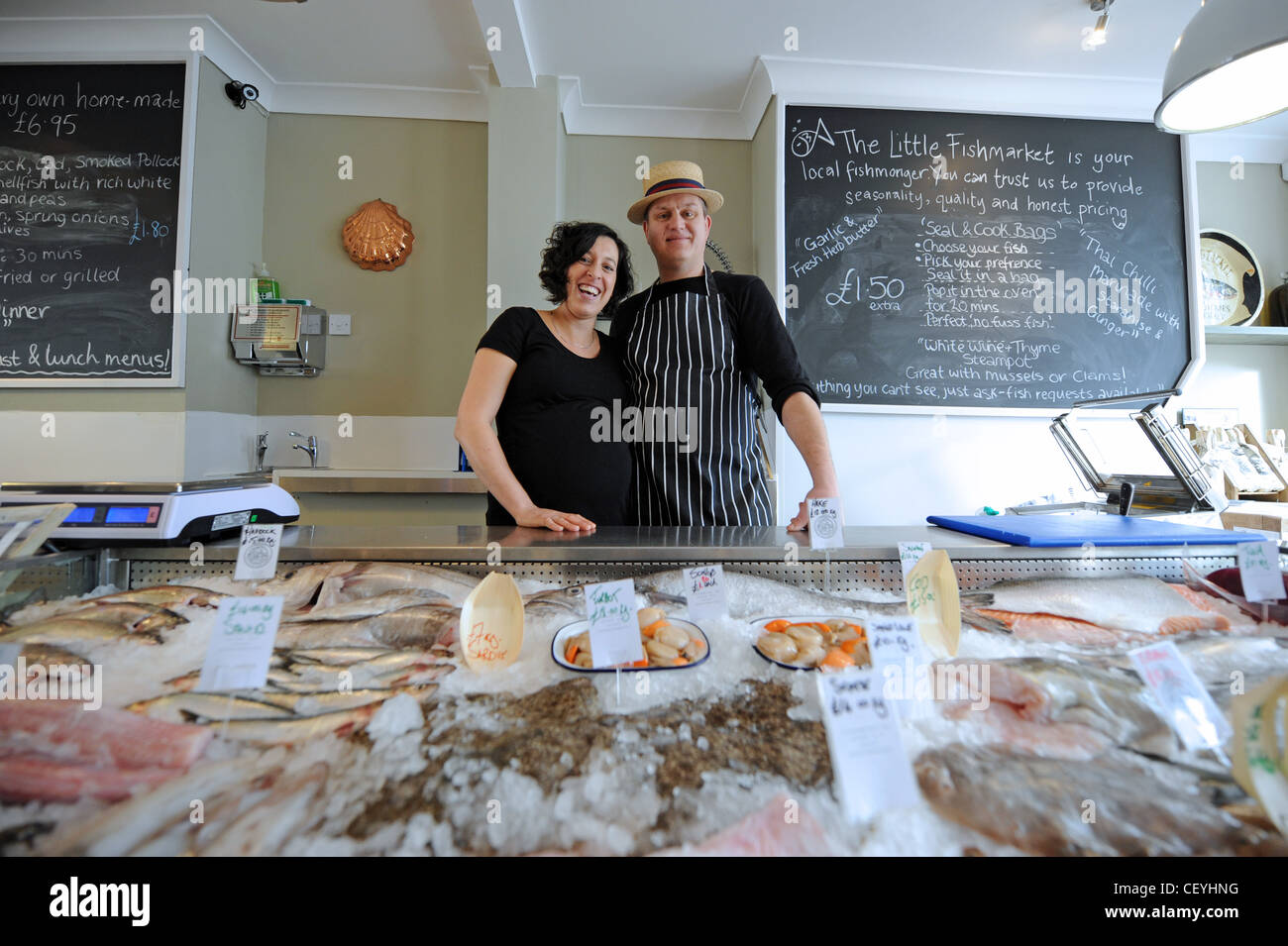 Owners of the Little Fishmarket fishmongers and deli cafe in Brighton UK with display of fresh local fish Stock Photo