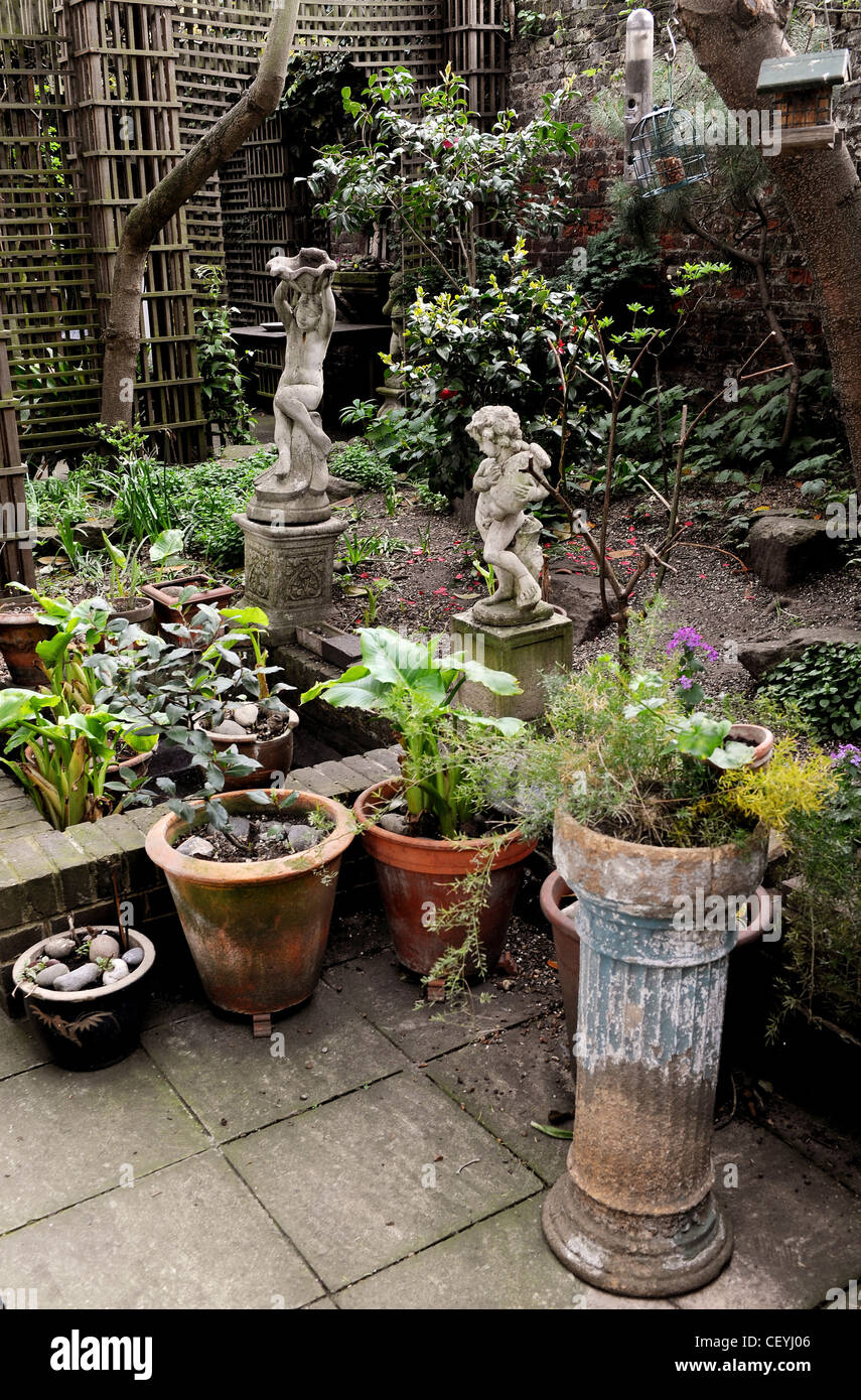 Hidden Treasure Paved Patio Trellis Potted Plants Statues Small