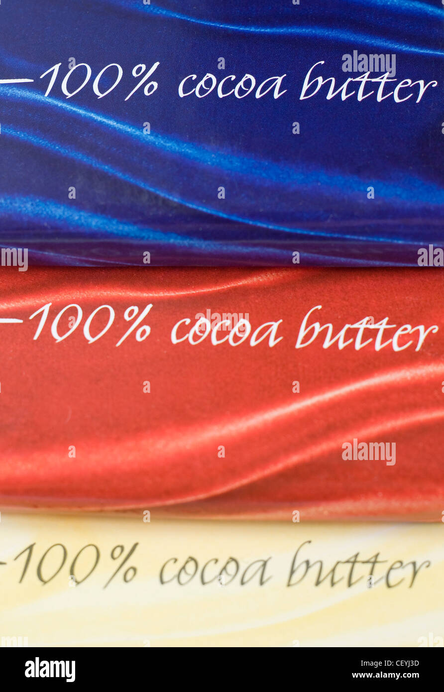 A still life image of blue, red and yellow chocolate wrapping paper with per cent cocoa butter written on it Stock Photo