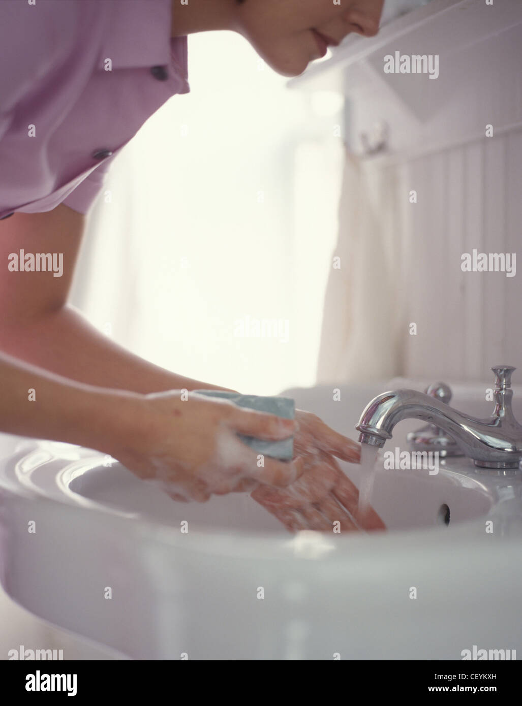 Woman washing hands with soap under tap hi-res stock photography and ...