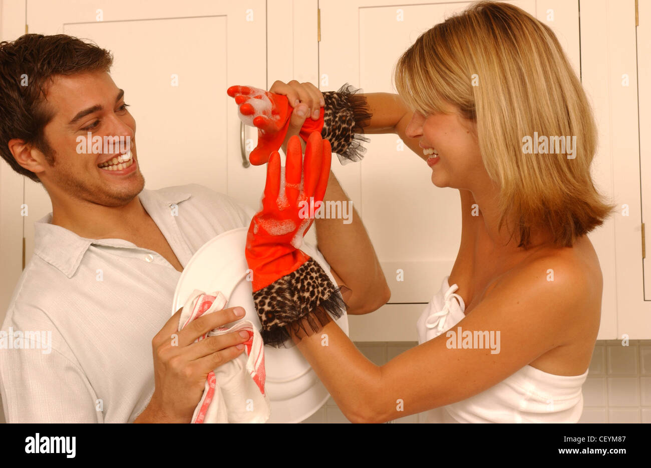 Couple In Kitchen Male Short Wavy Dark Hair Wearing White Short