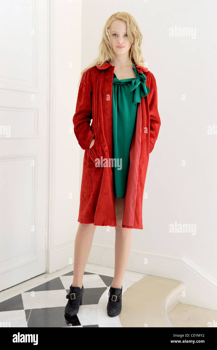 Agnes B Paris Ready to Wear Autumn Winter Red knee length coat, green dress  with bow detail and black ankle boots with buckles Stock Photo - Alamy