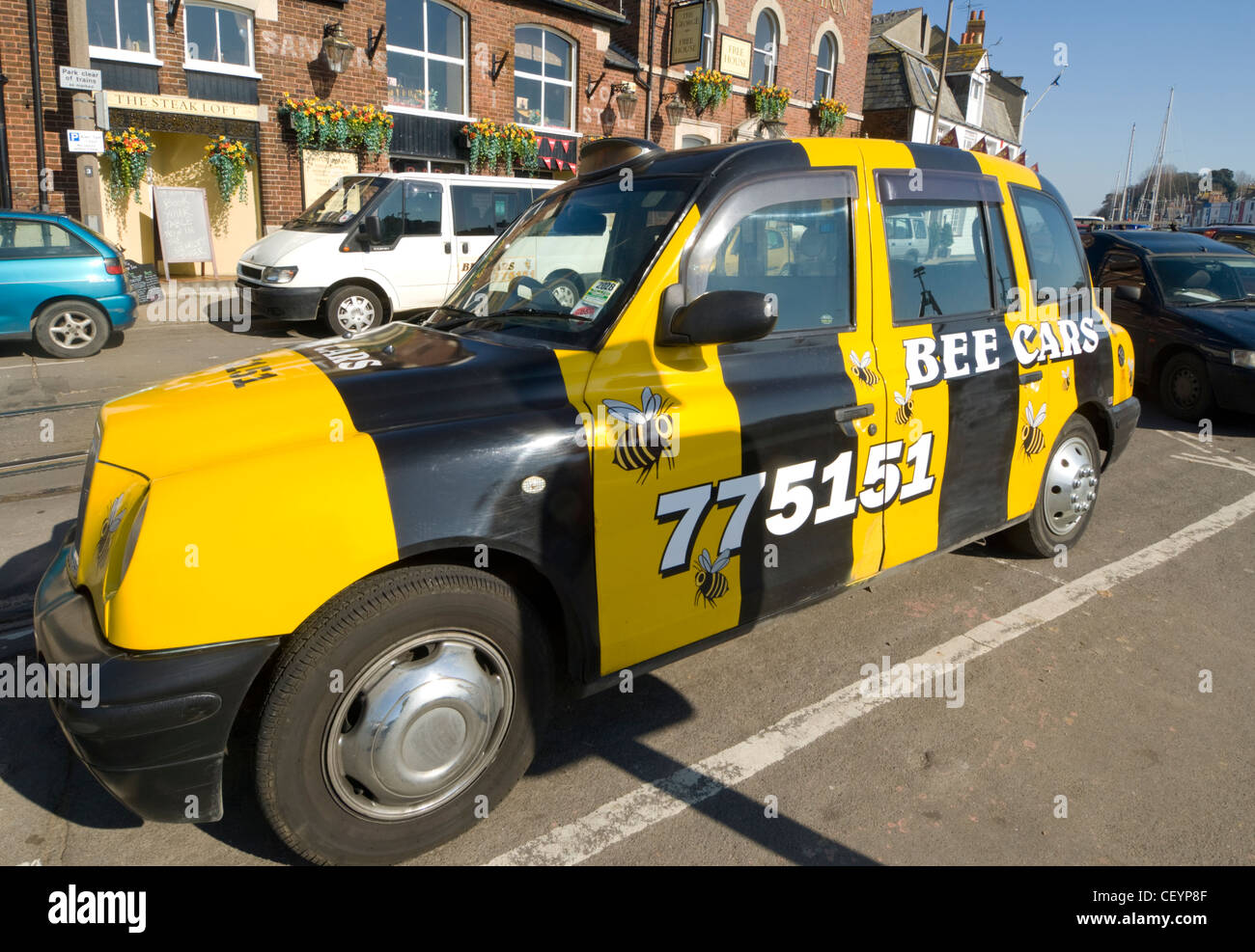 Black and Yellow Taxi Weymouth Dorset UK Stock Photo