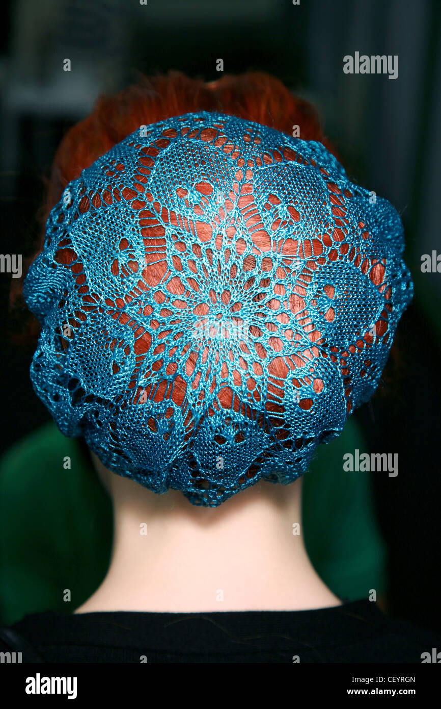 Jean Paul Gaultier Backstage Paris Ready to Wear Autumn Winter Back view of model red hair wearing blue crocheted cap covering Stock Photo