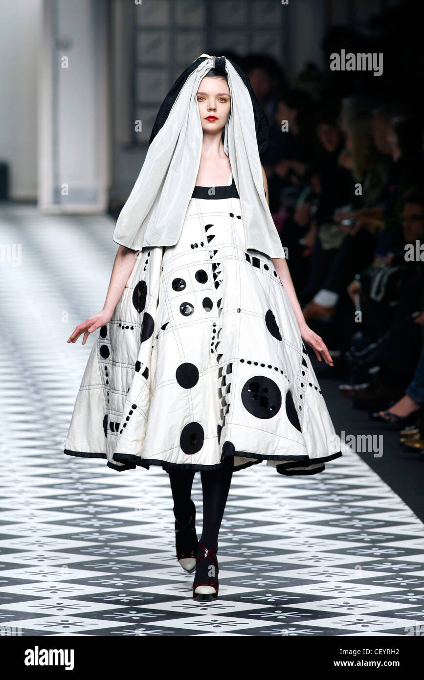 Antonio Marras Milan Fashion Week Autumn Winter Model wearing cream bell shaped dress black applique spots and stitched quilted Stock Photo