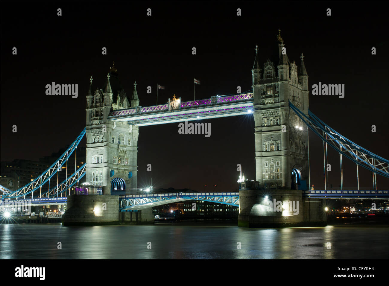 Tower Bridge with the walkways illuminated purple for Valentines Day. Long Exposure Stock Photo
